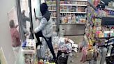 Moment quick-thinking worker traps machete robbers inside shop