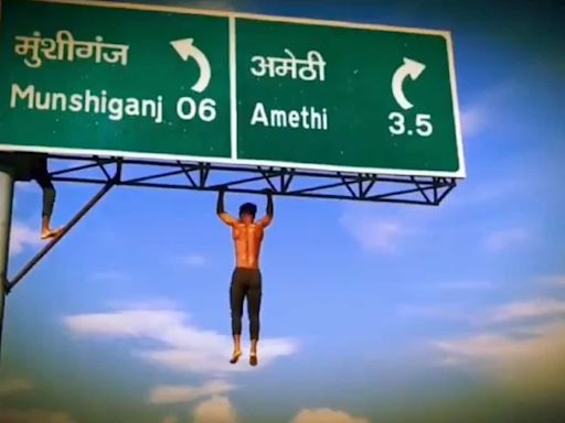 Shirtless man performs pull ups while hanging on 30-ft signboard. Watch video viral