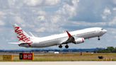 Australian police arrest a man accused of running naked through an airliner