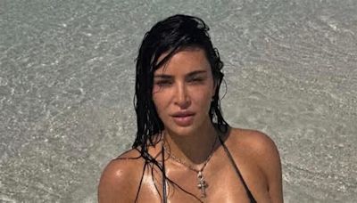 Kim Kardashian baffles fans as she dives in ‘knee-deep water’ for new bikini photos from tropical vacation