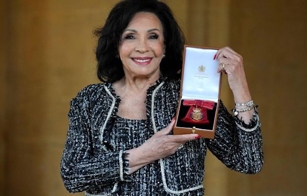 Shirley Bassey receives the award from King Charles