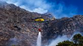 Firefighters battle a wildfire on the slopes of a mountain near Cape Town in South Africa