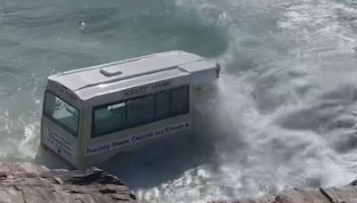 Shocking moment abandoned ice cream van is swept out to sea by powerful waves