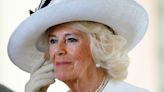 Queen Camilla pairs blue embellished tunic and trousers with $59k diamond earrings