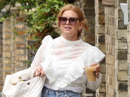 Isla Fisher looks typically chic in a sheer white blouse in Hampstead