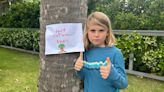 8-year-old fights to save town's trees from removal with heartfelt signs