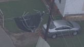 Storm blows trampoline into power lines, suspending it midair outside home