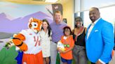 Extending a paw: Coach Dabo Swinney helps deliver My Special Aflac Duck® to children ahead of the Aflac Kickoff Game