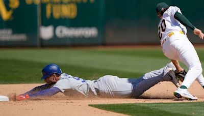 Kevin Kiermaier of the Los Angeles Dodgers gets caught attempting to steal second base tagged out by Zack Gelof of the Oakland Athletics in the top of the ninth inning at the ...