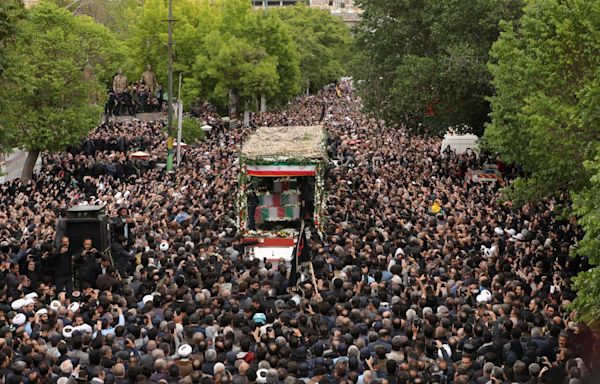 Thousands turn out to mourn Iran’s President Raisi as others celebrate his death