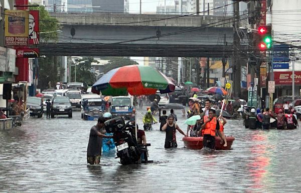 Monsoon rains worsened by offshore typhoon leave 8 dead and displace 600,000 in Philippines