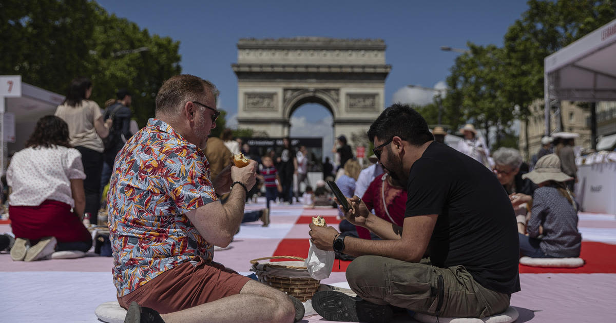 Paris' famous Champs-Elysees turned into a mass picnic blanket for an unusual meal