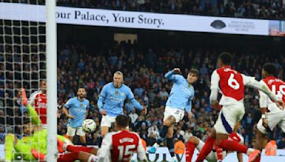 John Stones scores in injury time as Manchester City salvages a 2-2 draw with 10-man Arsenal