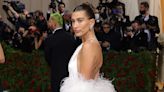 Hailey Bieber Wears a White Backless Gown and Feather Shawl to the Met Gala