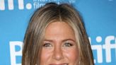 Jennifer Aniston Flaunts Her Toned Legs In A Silky Floral Wrap Skirt In New 'Murder Mystery 2' Clip