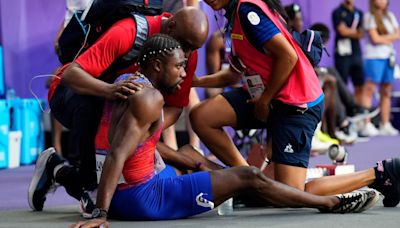 Medics tend to Noah Lyles, cart him away from track after men's 200 final