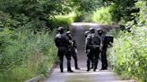 Armed cops swoop in on cemetery as Kyle Clifford manhunt continues