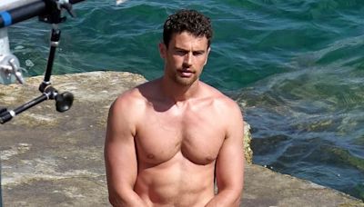 Shirtless Theo James shows off his hunky physique in white trunks