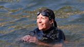 Decked out in a wet suit and a pair of goggles, Paris mayor Anne Hidalgo finally takes a dip in the Seine River