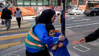 With a vest and a voice, helpers escort kids through San Francisco’s broken Tenderloin streets