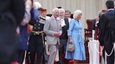 King Charles and Queen Camilla pulled into hotel after aide 'whispers in her ear'