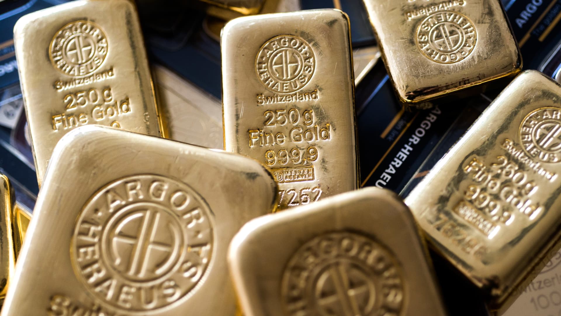 Gold slips as Fed meeting looms, but sees third monthly gain