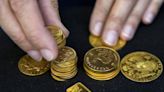 Gold prices dip as dollar holds ground