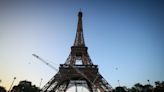 Paris Olympics organizers unveil a display of the five Olympic rings mounted on the Eiffel Tower