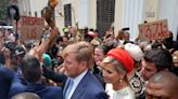 Dutch king and queen are confronted by angry protesters on visit to a slavery museum in South Africa