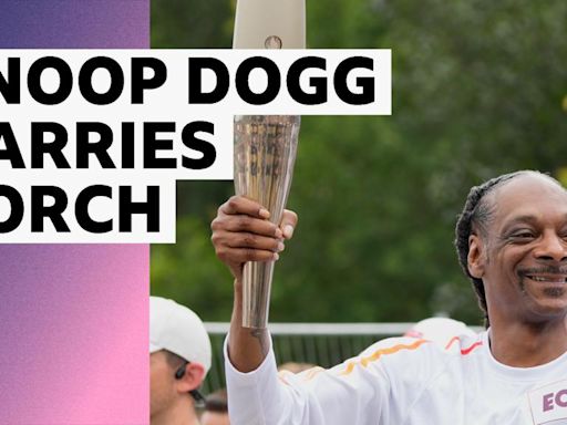 Rapper Snoop Dogg carries Olympic torch through Paris