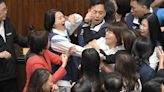 Moment parliament brawl breaks out with MPs punching & tackling each other