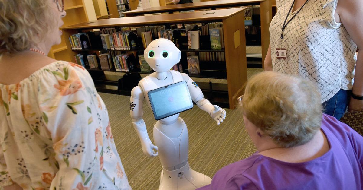 Reading robot spending the summer in the library