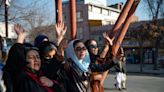 Afghan Taliban use barbed wire fence and armed guards to keep women out of universities