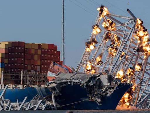 Collapsed Baltimore bridge span comes down with a boom after crews set off chain of explosives