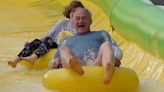 Ed Davey rides rubber ring on waterslide as Lib Dems campaign about children’s mental health