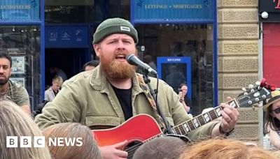 Brit Awards winner Tom Walker performs in Huddersfield town centre