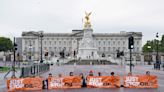 Just Stop Oil protesters blocking road to Buckingham Palace glue themselves to The Mall