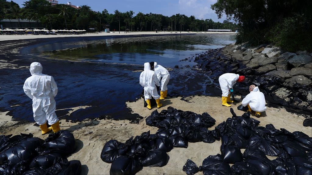 Singapore continues rush to clean up oil slick after boat hits stationary fuel supply ship