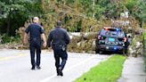 A police officer barely escapes a falling tree as storm blows through South Shore