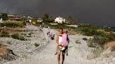 Fire still blazing on the Greek island of Rhodes as dozens more erupt across the country