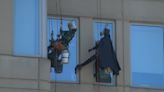 ‘It means everything’: Batman cleans windows, greets hospitalized children