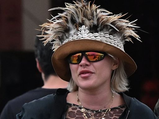 Florence Pugh turns heads in a quirky feathered hat at Glastonbury
