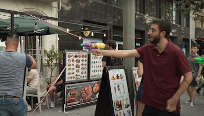 Protestors Spray Tourists with Water Guns During Demonstration Against Overtourism in Barcelona