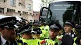 Metropolitan Police officers clash with protesters taking part in a gathering around a bus reportedly waiting to remove migrants and asylum seekers from a hotel in Peckham, south London