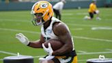 AJ Dillon runs the stairs at an empty Lambeau Field and teammate Keisean Nixon tells him to go on vacation