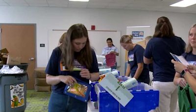 Heaven Hill interns pack backpacks with supplies for Perry Elementary School students