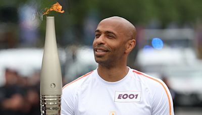 France manager Thierry Henry carries Olympic torch through Paris