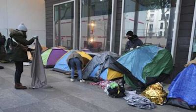 Police clear out a migrant camp in central Paris. Activists say it's a pre-Olympics sweep