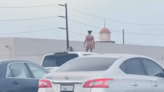 Police confront nude woman standing atop moving SUV on busy L.A. freeway