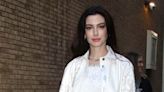 Anne Hathaway looks like a 90s boyband heartthrob in white cargos and rhinestones